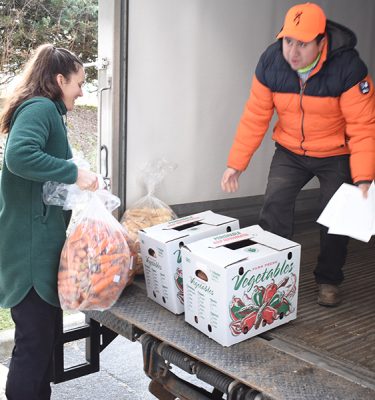 Left, Jenny Linger and Erick Saucedo of the Farm Hub on a weekly food distribution run.