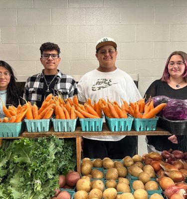 Members of the Kingston YMCA Farm Project's Youth Crew staff the winter farm stand.